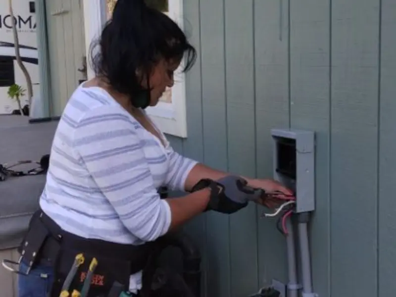 Licensed electrician wiring an exterior subpanel in Deming